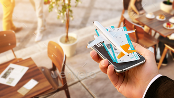 g and booking flights on the internet. Unusual 3D illustration of commercial airplane and boarding passes on smart phone in hand