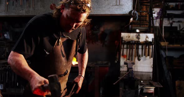 Blacksmith working on a iron rod