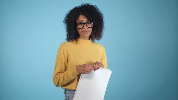 Breaking Contract. Furious Young African American Woman with Afro Hairstyle Tearing Up Paper with