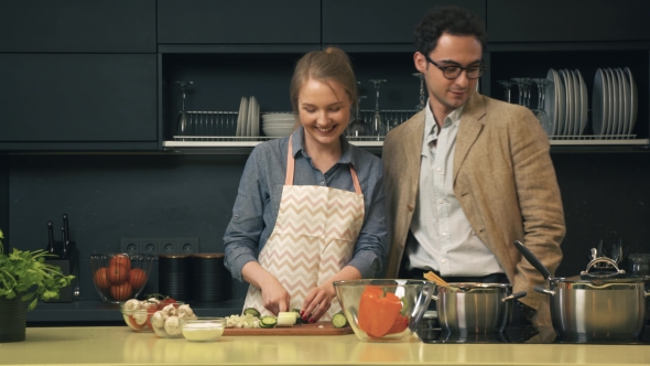 Young and Happy Couple in the Kitchen