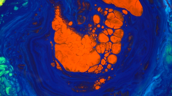 Footage. Ink in Water. Red in Blue Ink Reacting in Water Creating Abstract Background