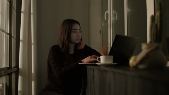 Charming Asian Woman Working with Laptop at Night