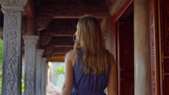 Steadycam Shot of a Young Woman Walking Inside of a Buddhist Temple. Ho Quoc Pagoda on Phu Quoc