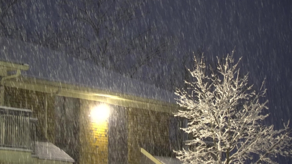 Snow Falls at Night in the Street with Lanterns