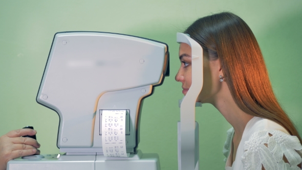 Medical Examination of a Young Woman's Eyesight with Moving Machine