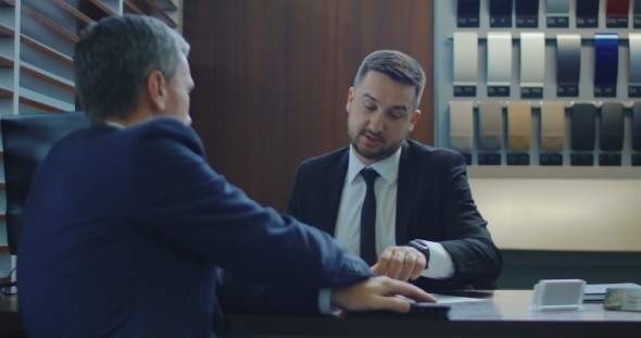 Man Paying with Credit Card Then Receiving Car Key