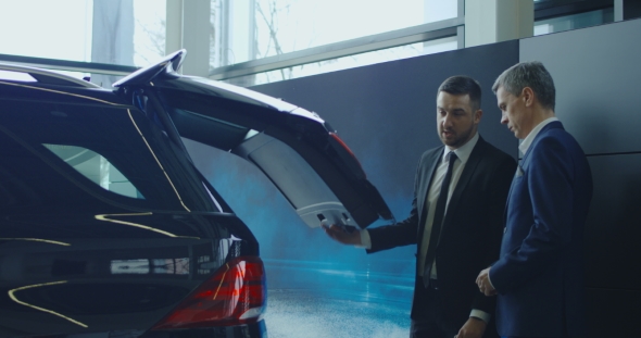 Agent Showing Trunk To Man