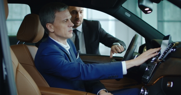 Manager Showing Car To Businessman