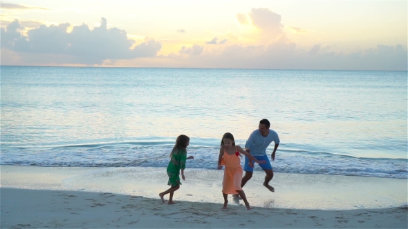 Father and Kids Enjoying Beach Summer Tropical Vacation at Sunset.