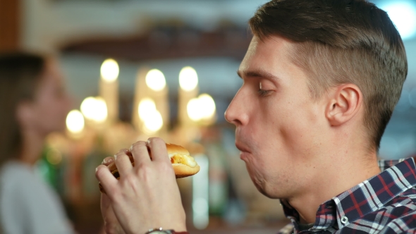 Man in a Restaurant Eating a Hamburger