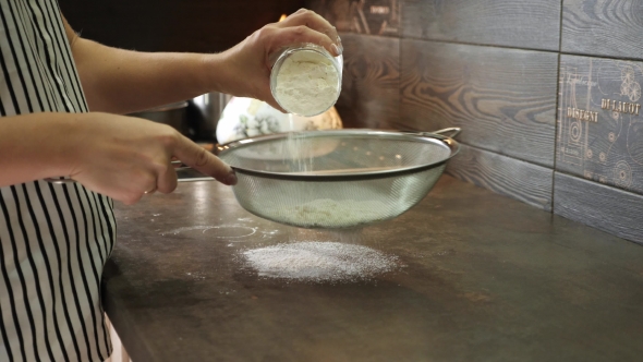 Woman Sifting Flour Through Sieve.