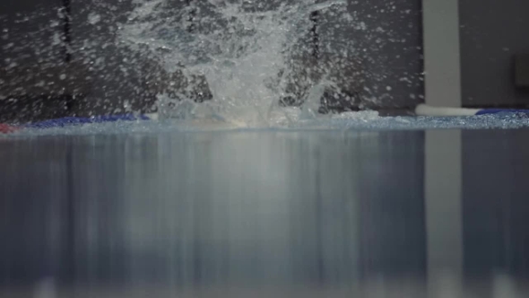 Female Professional Swimmer Floating Butterfly Stroke in Water Pool