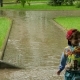 The Boy Runs through the Puddle in the Rain - VideoHive Item for Sale