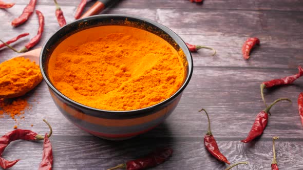 Chili Powder and Dried Peppers on Table Background