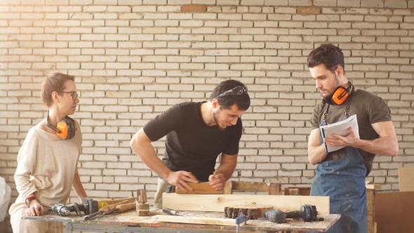 Carpenter Working With Plane on Wooden Background.