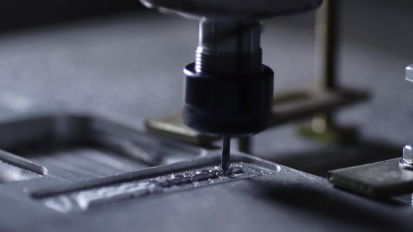 In a Beautiful Light, the Drill Bit Slowly Carves Out the Aluminum Plate Company Name for