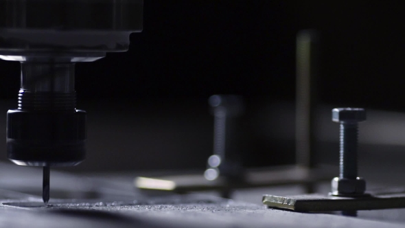 In a Beautiful Light, the Drill Bit Slowly Carves Out the Aluminum Plate Company Name for