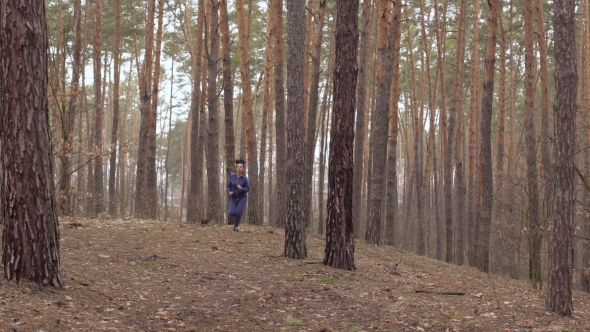 Young Beautiful Woman Is Running in the Forest