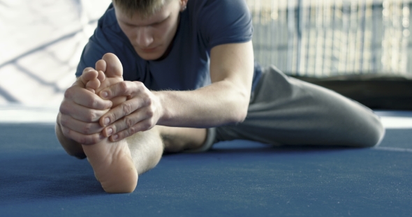 Sportsman Stretching in Gym