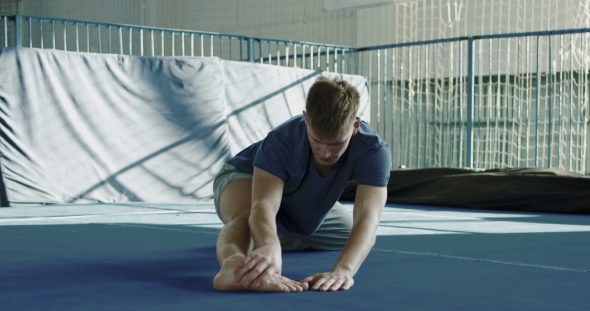 Sportsman Stretching in Gym