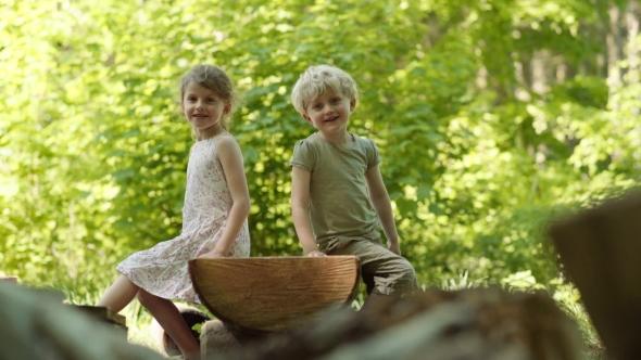 Kids Sitting in Forest
