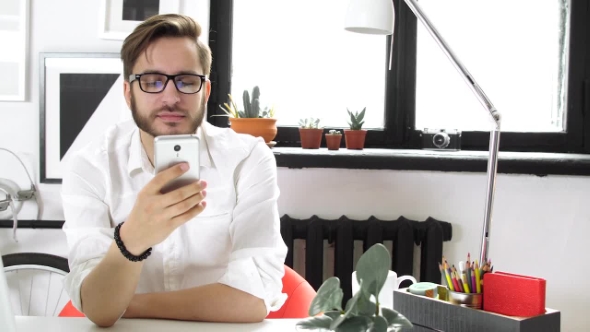 Man Using Smartphone and Chatting, Rest in Office
