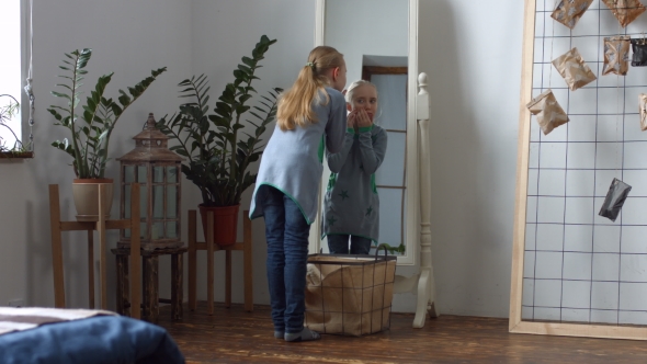 Sad Little Girl Finding an Acne on Her Face alt