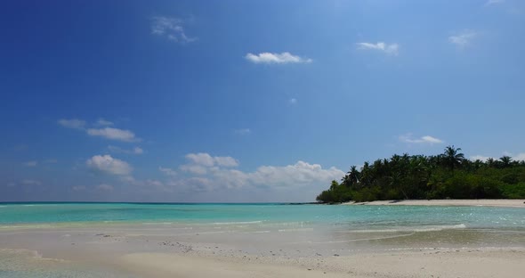 Daytime aerial tourism shot of a white sandy paradise beach and blue ocean background in best quality