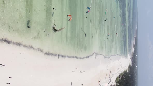 Vertical Video Kitesurfing Near the Shore of Zanzibar Tanzania Aerial View