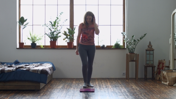 Shocked Adult Woman Standing on Weighing Scales