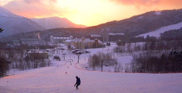 Snowboarder Going down Mountain into Incredible Sunset