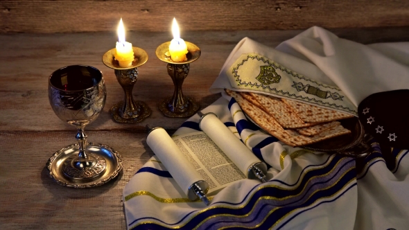 A Table Set for Shabbat with Challah Bread, Candlesticks and Wine. Wood Background.