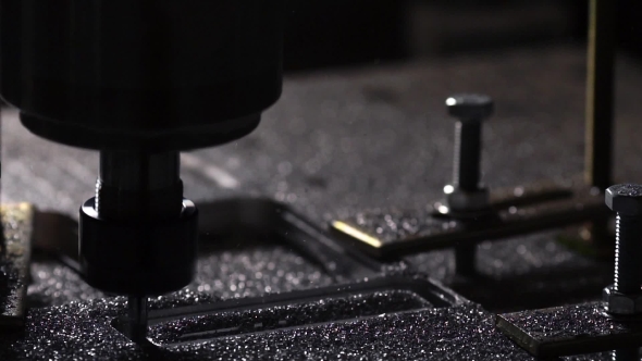 In a Beautiful Light, the Drill Bit Slowly Carves Out the Aluminum Plate Company Name for