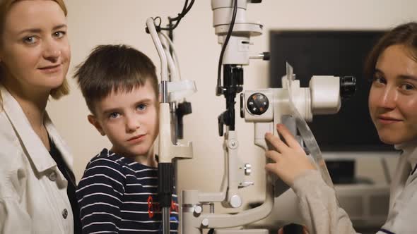 Eye Doctor with Patients Look at Camera at Modern Opthalmology Medical Device