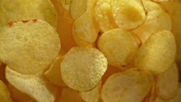 Super Slow Motion Shot of Potato Chips Flies After Being Exploded Against Black Background 1000Fps