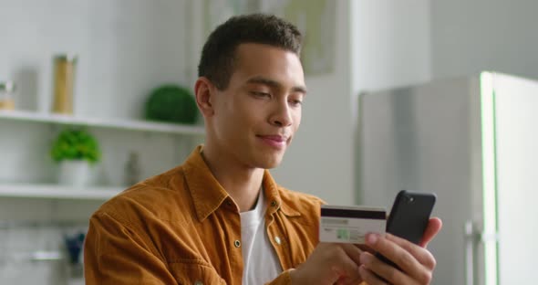 Young Latin Man Fills Online Shopping Form at Home, Close Up