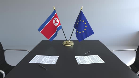 Flags of North Korea and the European Union on the Table