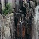 Aerial view waterfall with black columns on the sides of canyon - VideoHive Item for Sale