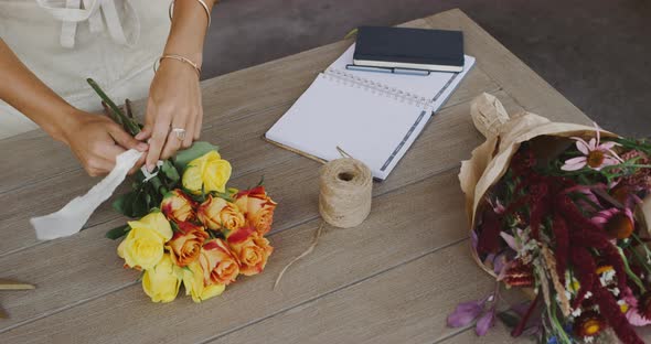 Florist preparing flower bouquet alt