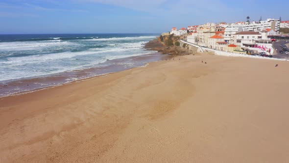 Aerial Drone View of Sandy Beach at Lisbon, Portugal at Praia das Macas, a Beautiful Coastal Town on