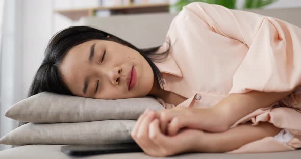 Asian woman leaning down on a pillow