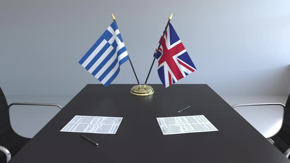 Flags of Greece and Great Britain on the Table