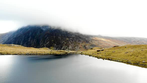 Aerial footage Cwm Idwal, beautiful lake in Snowdonia National Park, North Wales on a very windy day