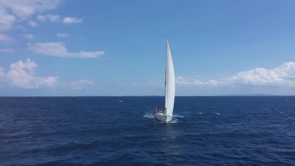 Yacht Sailing at Sunset During a Storm