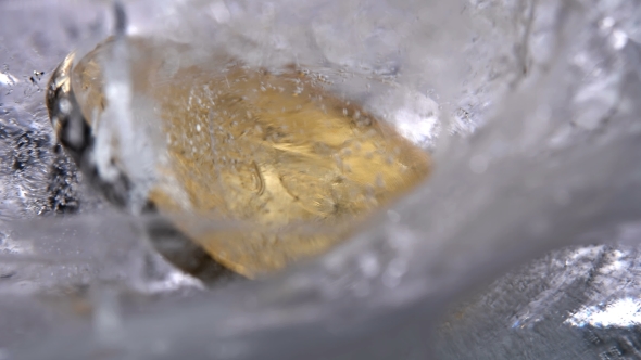 Coin Frozen in Transparent Ice, , Slowly Spinning