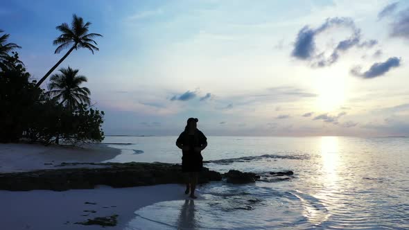 Lady alone loves life on tropical coastline beach lifestyle by transparent water and white sand back