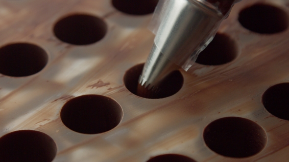 Pastry Bag Filling Candy Mold Form with Chocolate Cream