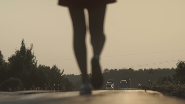 The Girl Is Walking Along the Motorway