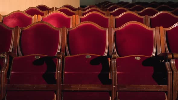 Theater Seats Row Lit By Spotlight Red Velvet Chairs in Empty Theatre Hall