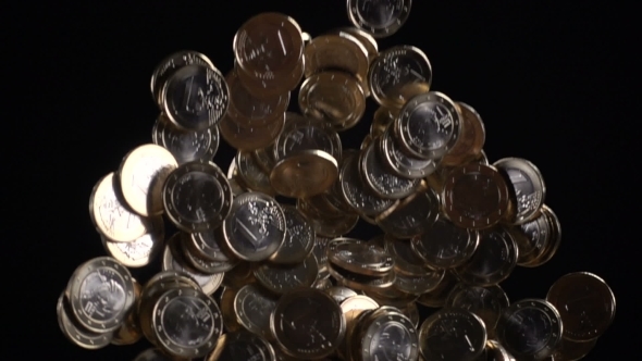 One Euro Coins Fall on a Black Background